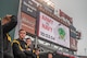 service members standing in front of Army vs. Navy signage