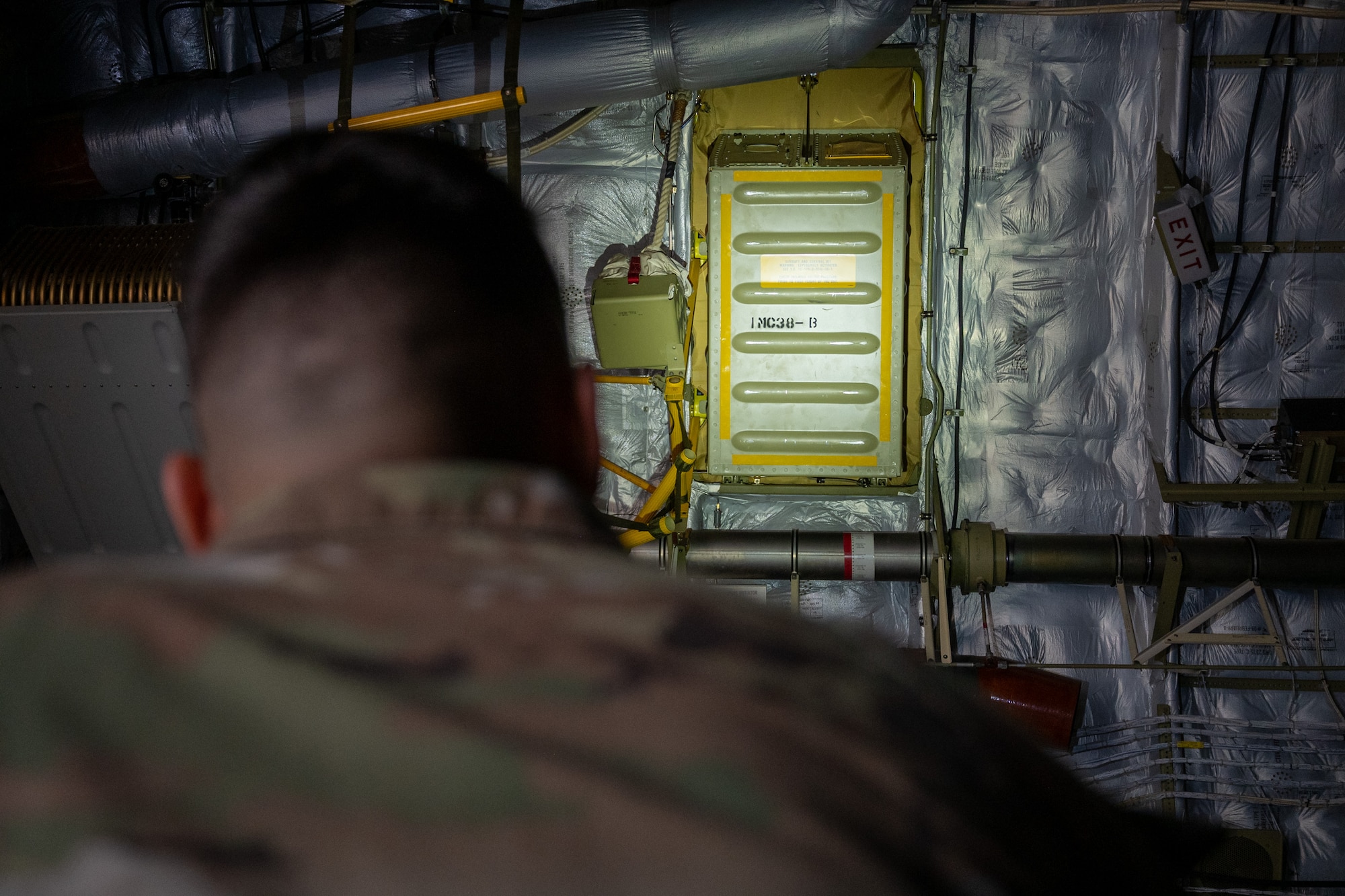 U.S. Air Force Staff Sgt. Spencer Maki, 62d Operations Support Squadron aircrew flight equipment technician, inspects a life raft rigid container on a C-17 Globemaster III at Joint Base Lewis-McChord, Washington, Dec. 10, 2024.