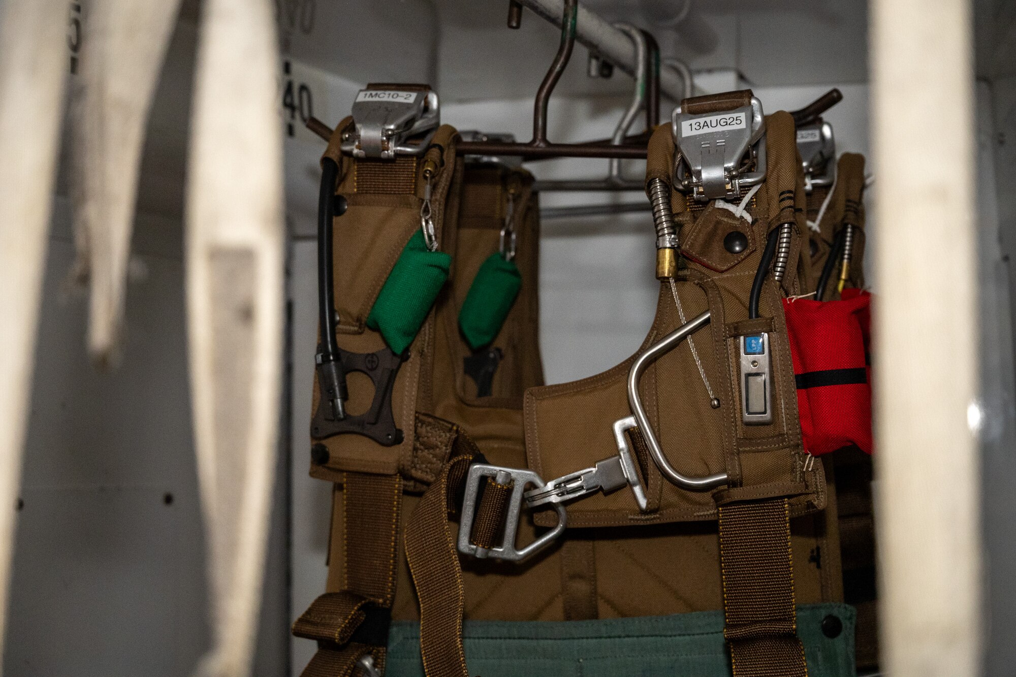 BA-30 parachutes hang in the aircrew flight equipment storage closet on a C-17 Globemaster III at Joint Base Lewis-McChord, Washington, Dec. 10, 2024.