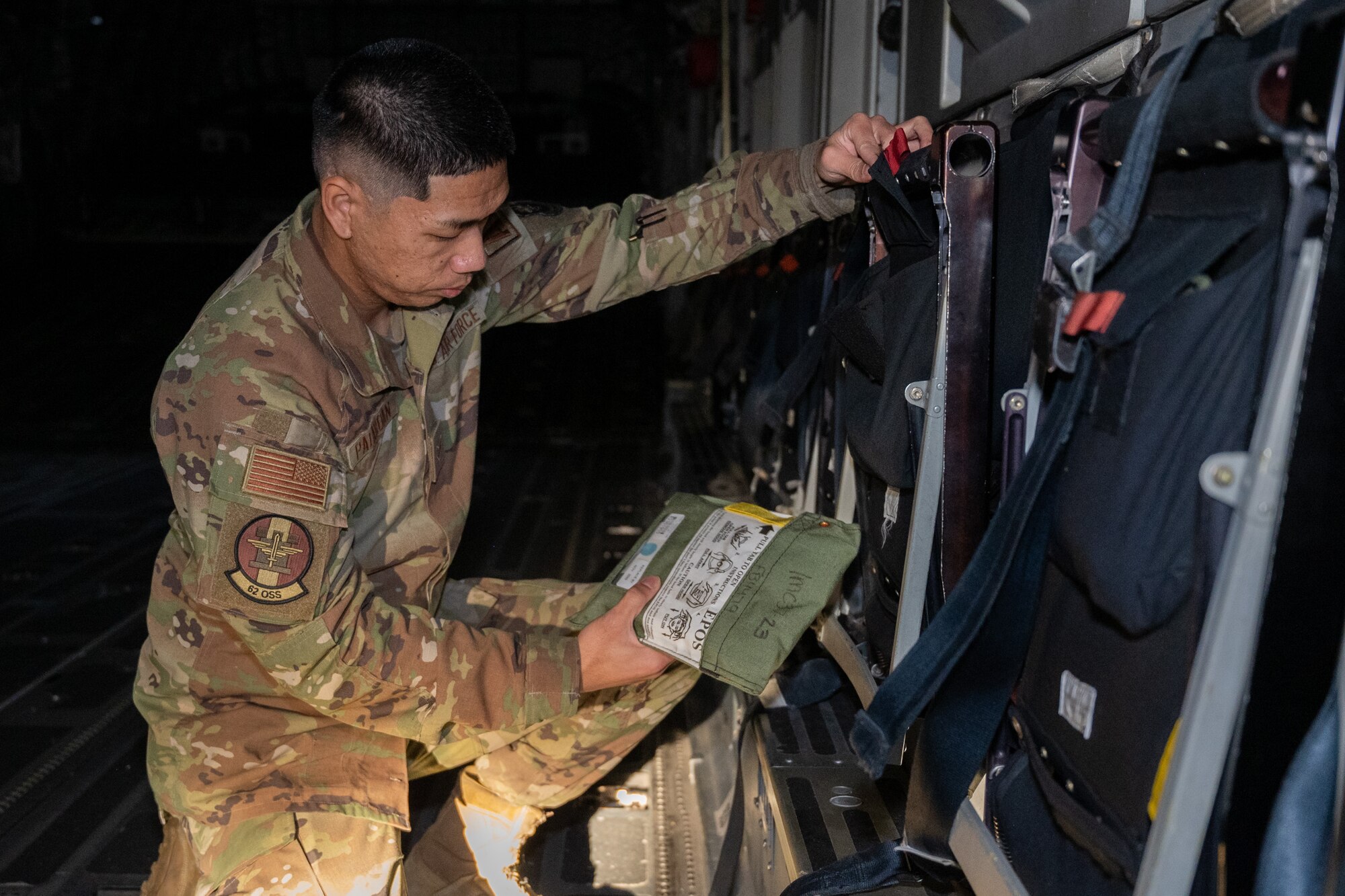 U.S. Air Force Senior Airman Brysen Palaroan, 62d Operations Support Squadron aircrew flight equipment technician, inspects an emergency passenger oxygen system on a C-17 Globemaster III at Joint Base Lewis-McChord, Washington, Dec. 10, 2024.