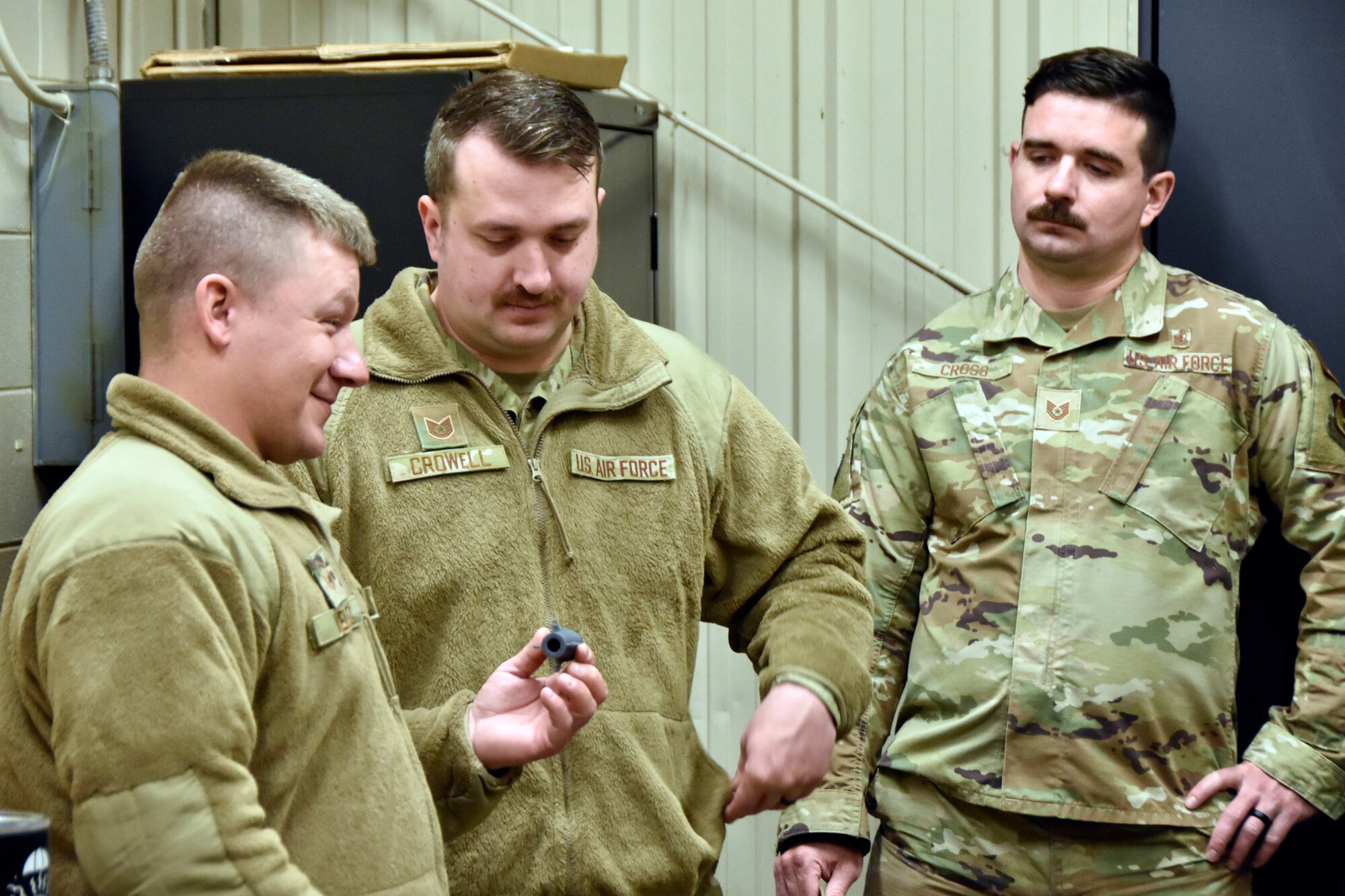 Master Sgt. Anthony Velez, left, Tech Sgt. Abel Crowell, center, and Tech Sgt. Ethan Cross look over an object 3D printed in the Innovation Lab at Arnold Air Force Base, Tenn., during a Dec. 12, 2024, tour of the facility given for Airmen at Arnold. The Innovation Lab was recently reopened following a renovation, and the facility features 3D printing and scanning capabilities, a computer lab, an environmental chamber, a shock tube and a small-scale wind tunnel. (U.S. Air Force photo by Bradley Hicks)