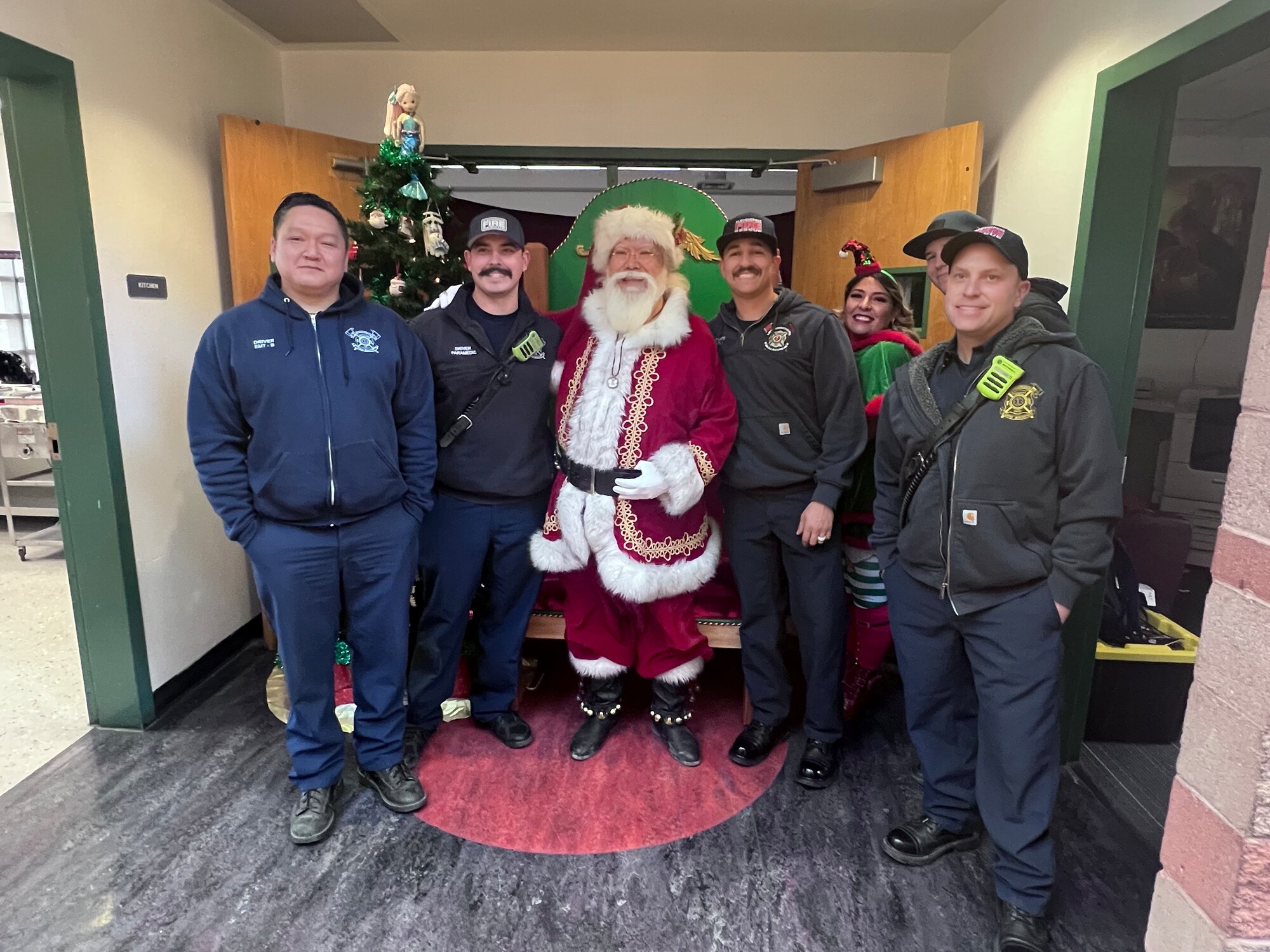 Kirtland Firefighters pose with santa claus