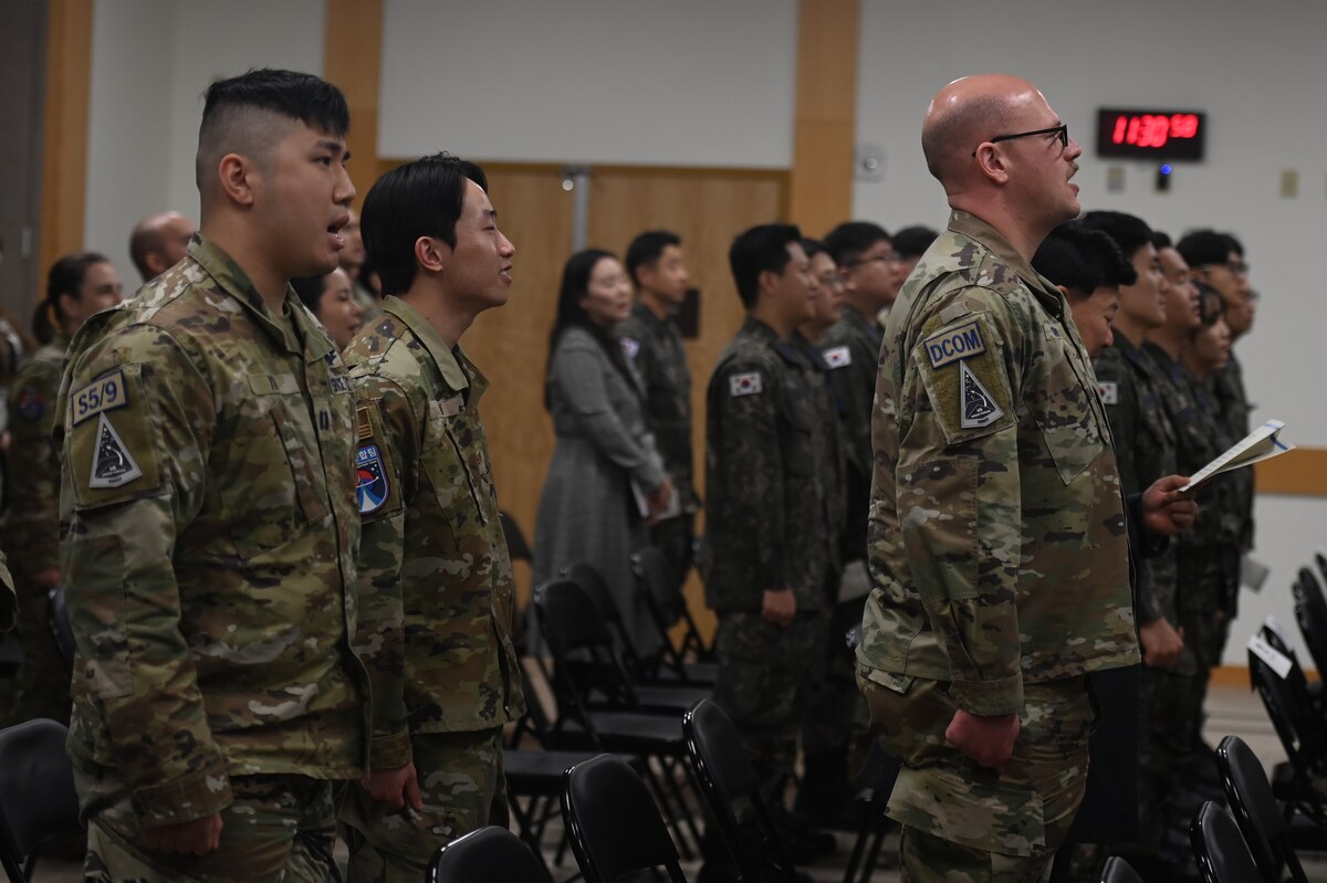 U.S. and Republic of Korea service members standing and singing