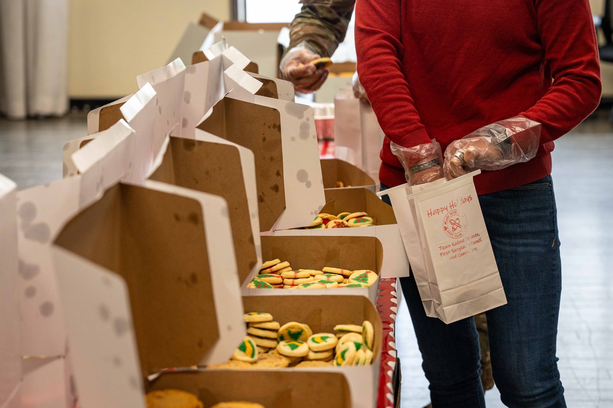 volunteer packs cookie bag with cookies