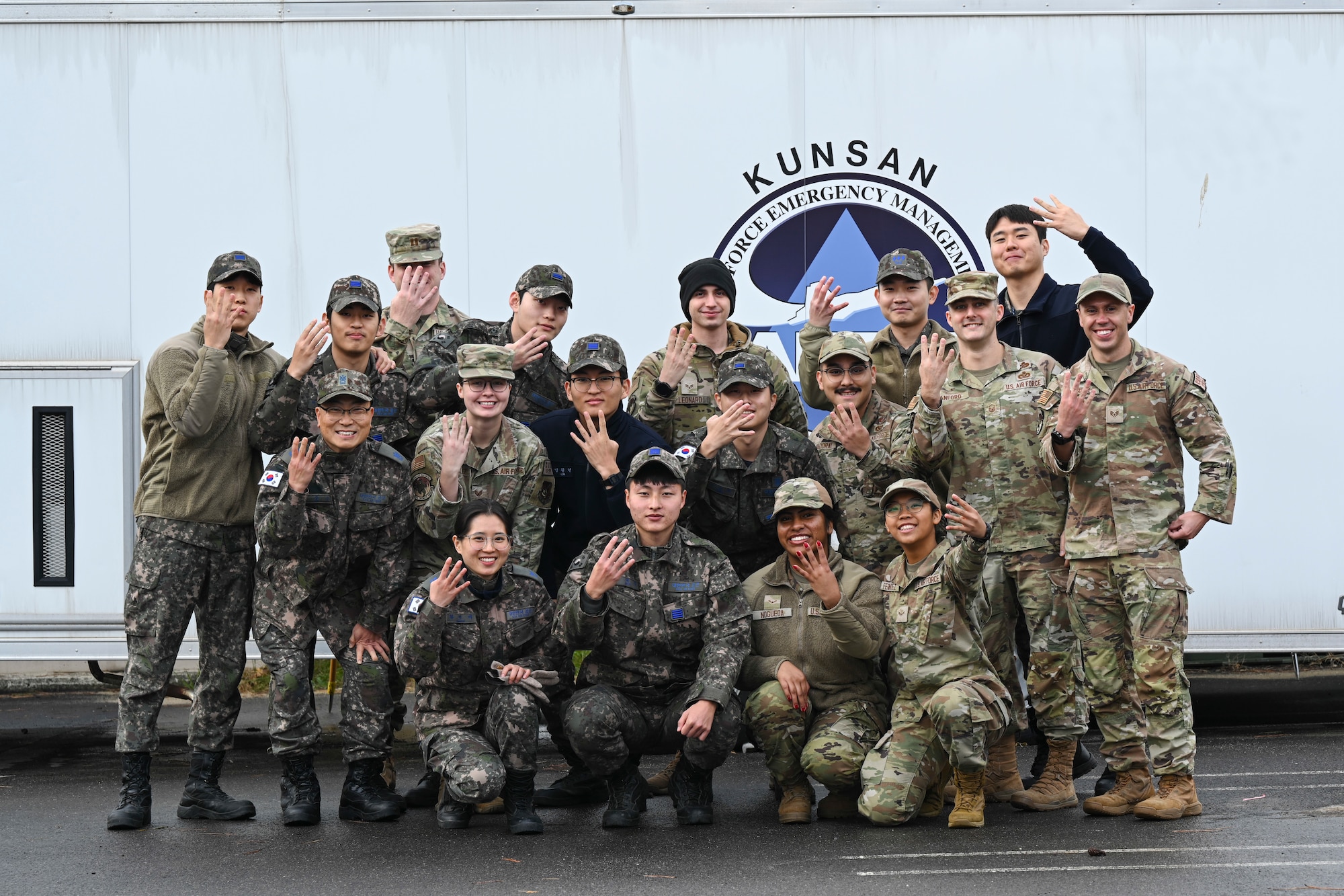 U.S. and Republic of Korea Air Force Airmen flash the 8th Civil Engineer Squadron “Red Devil” hand sign after Chemical, Biological, Radiological, and Nuclear training at Kunsan Air Base.