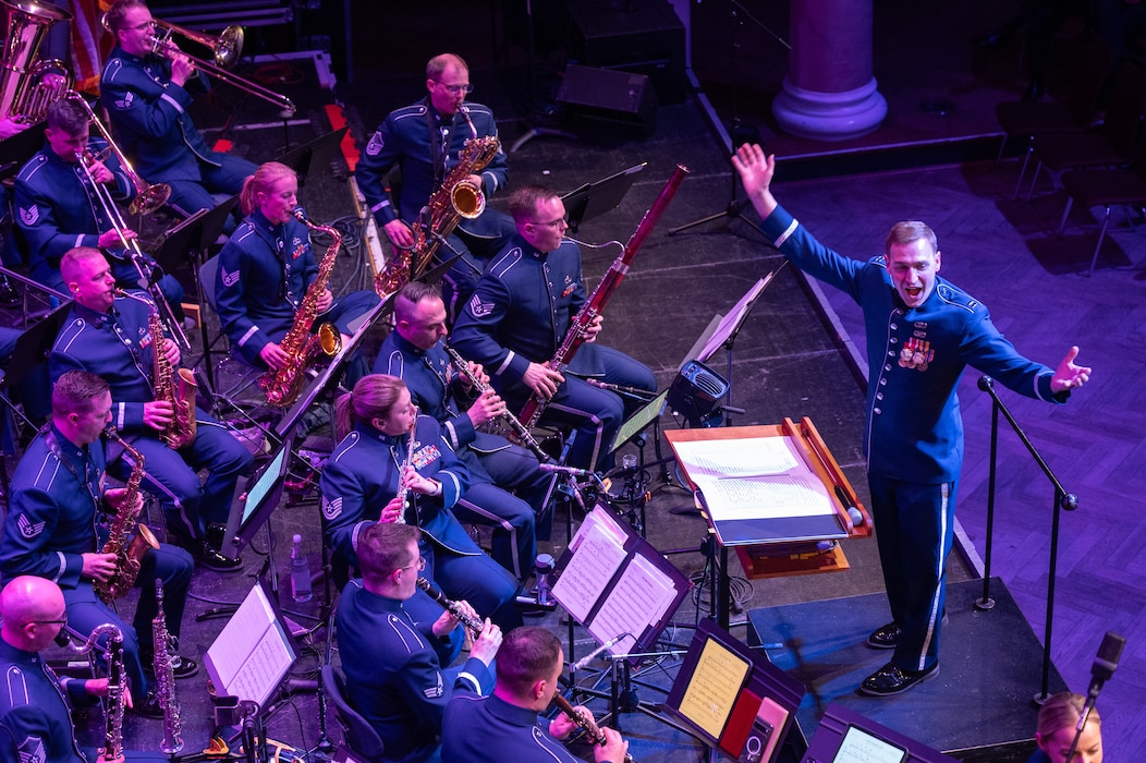 The U.S. Air Forces in Europe - Air Forces Africa Band and the Rheinland-Pfalz International Choir perform for an audience of military members and German nationals during the Kaiserslautern Military Community Christmas concert at the Fruchthalle in Kaiserslautern, Germany, Dec. 13, 2024. The USAFE-AFAFRICA band serves to increase cultural ties and enhance the continuous relationship between the U.S. and Germany. (U.S. Air Force photo by Senior Airman Renan Arredondo)