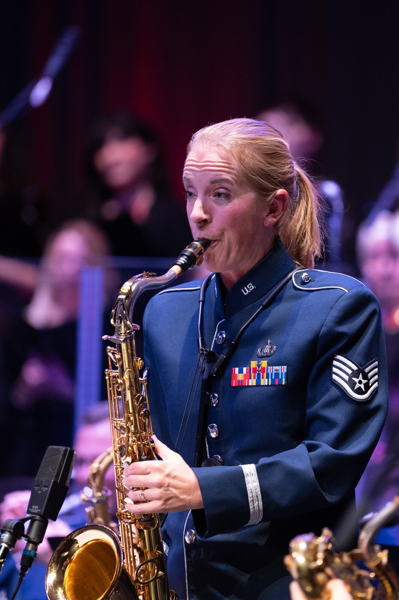 U.S. Air Force Staff Sgt. Sarah Cosano, U.S. Air Forces in Europe - Air Forces Africa Band member, plays the saxophone during the Kaiserslautern Military Community Christmas concert at the Fruchthalle in Kaiserslautern, Germany, Dec. 13, 2024. The USAFE-AFAFRICA Band serves to increase cultural ties and enhance the continuous relationship between the U.S. and Germany. (U.S. Air Force photo by Senior Airman Renan Arredondo)