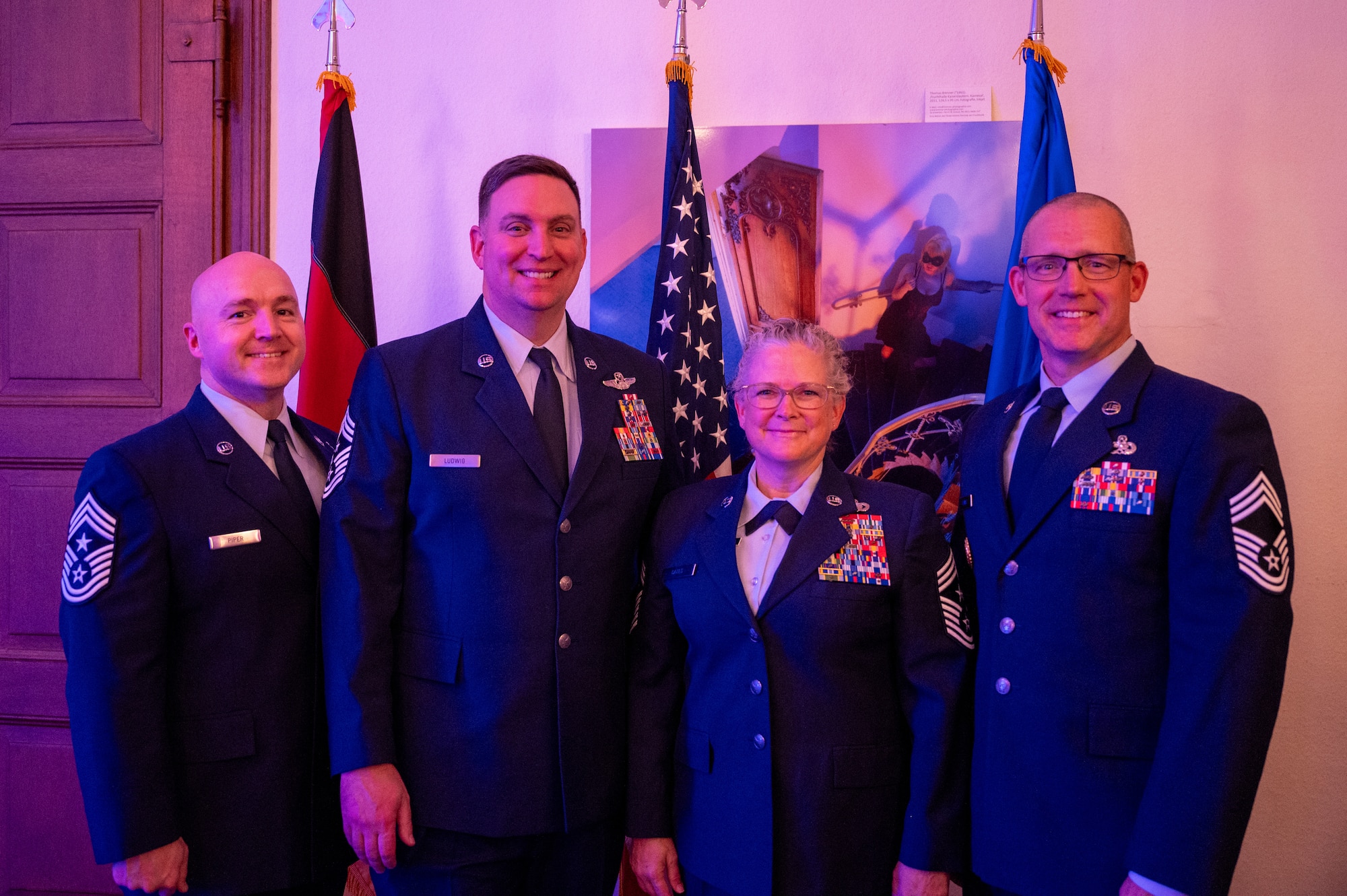 U.S. Air Force Chief Master Sergeants from the Kaiserslautern Military Community attend the KMC Christmas concert at the Fruchthalle in Kaiserslautern, Germany, Dec. 13, 2024. These concerts offer a platform for cultural exchange and sharing of musical traditions between the U.S. Air Force musicians and European audiences. (U.S. Air Force photo by Senior Airman Renan Arredondo)