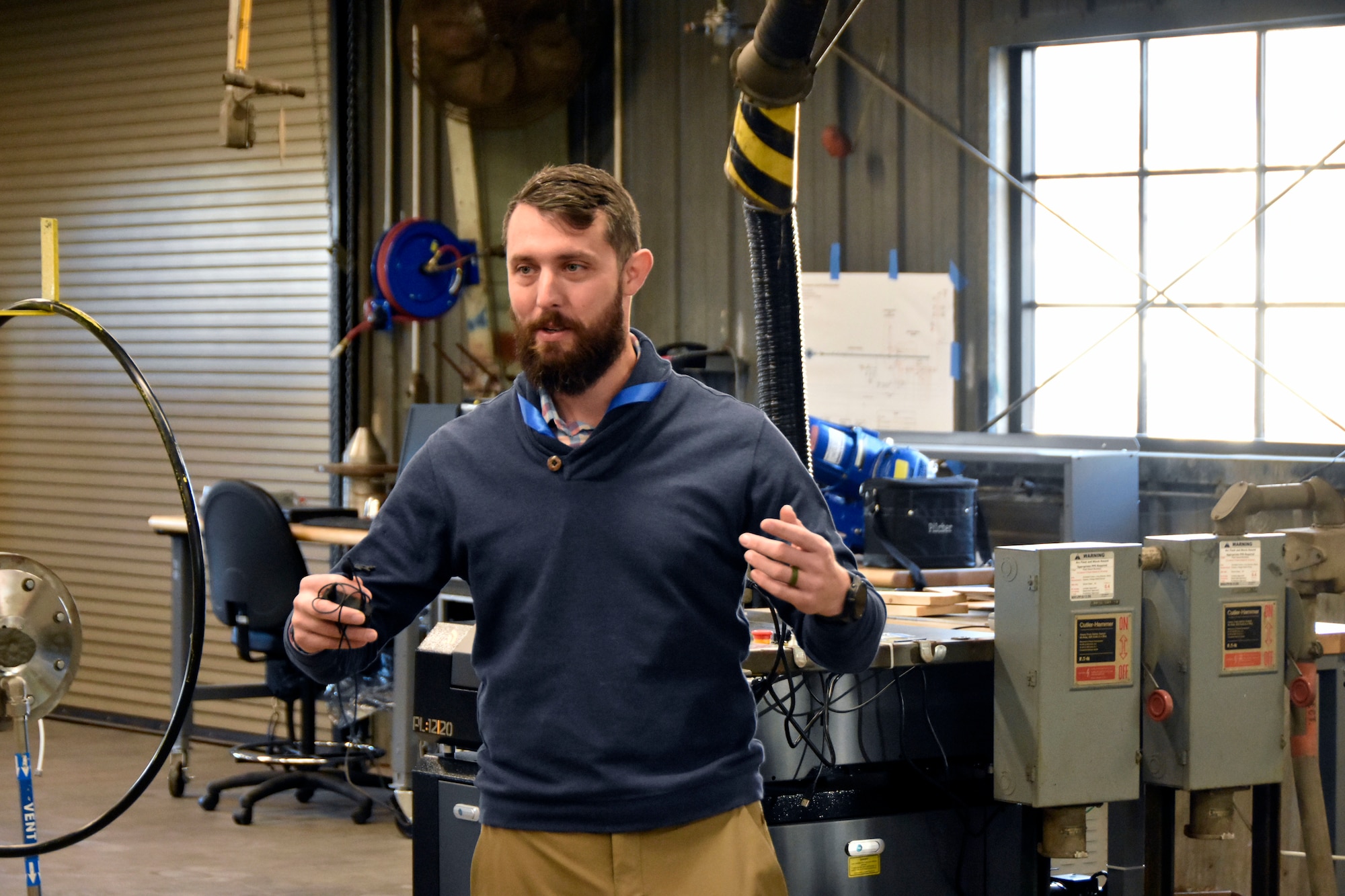 Arnold Engineering Development Complex Continuous Improvement Manager Pearson Brock talks about some of the resources offered to users of the Innovation Lab at Arnold Air Force Base, Tenn., during a Dec. 12, 2024, tour of the facility given for Airmen at Arnold. The Innovation Lab was recently reopened following a renovation, and the facility features 3D printing and scanning capabilities, a computer lab, an environmental chamber, a shock tube and a small-scale wind tunnel. (U.S. Air Force photo by Bradley Hicks)