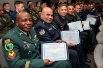 International military students hold certificates after their graduation from the Inter-American Air Forces Academy