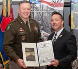Pennsylvania state representative Chris Pielli, right, presents a resolution commemorating the 80th anniversary of the Battle of the Bulge to Pennsylvania Acting Adjutant General Brig. Gen. John Pippy during a ceremony Dec. 16, 2024, at Fort Indiantown Gap, Pa. (Pennsylvania National Guard photo by Wayne V. Hall)