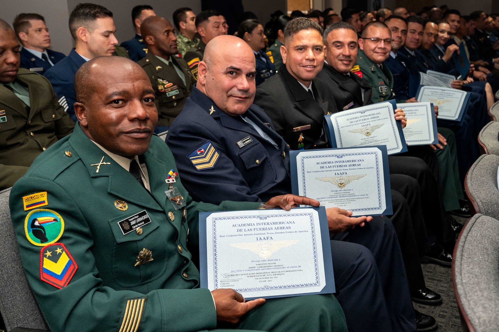 International military students hold certificates after their graduation from the Inter-American Air Forces Academy