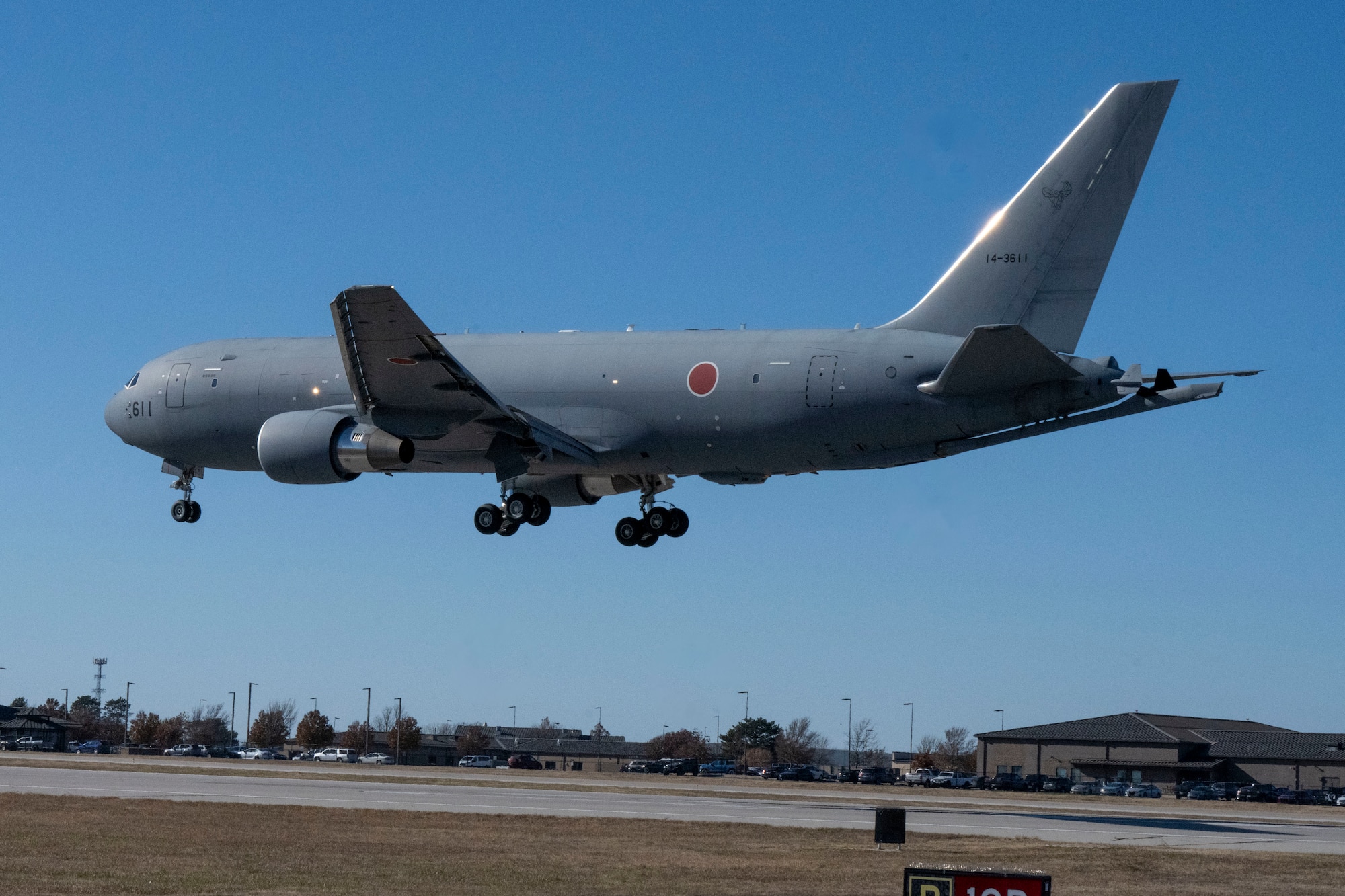 People group around to discuss operational capabilities relating to a KC-46 refueling airplane.