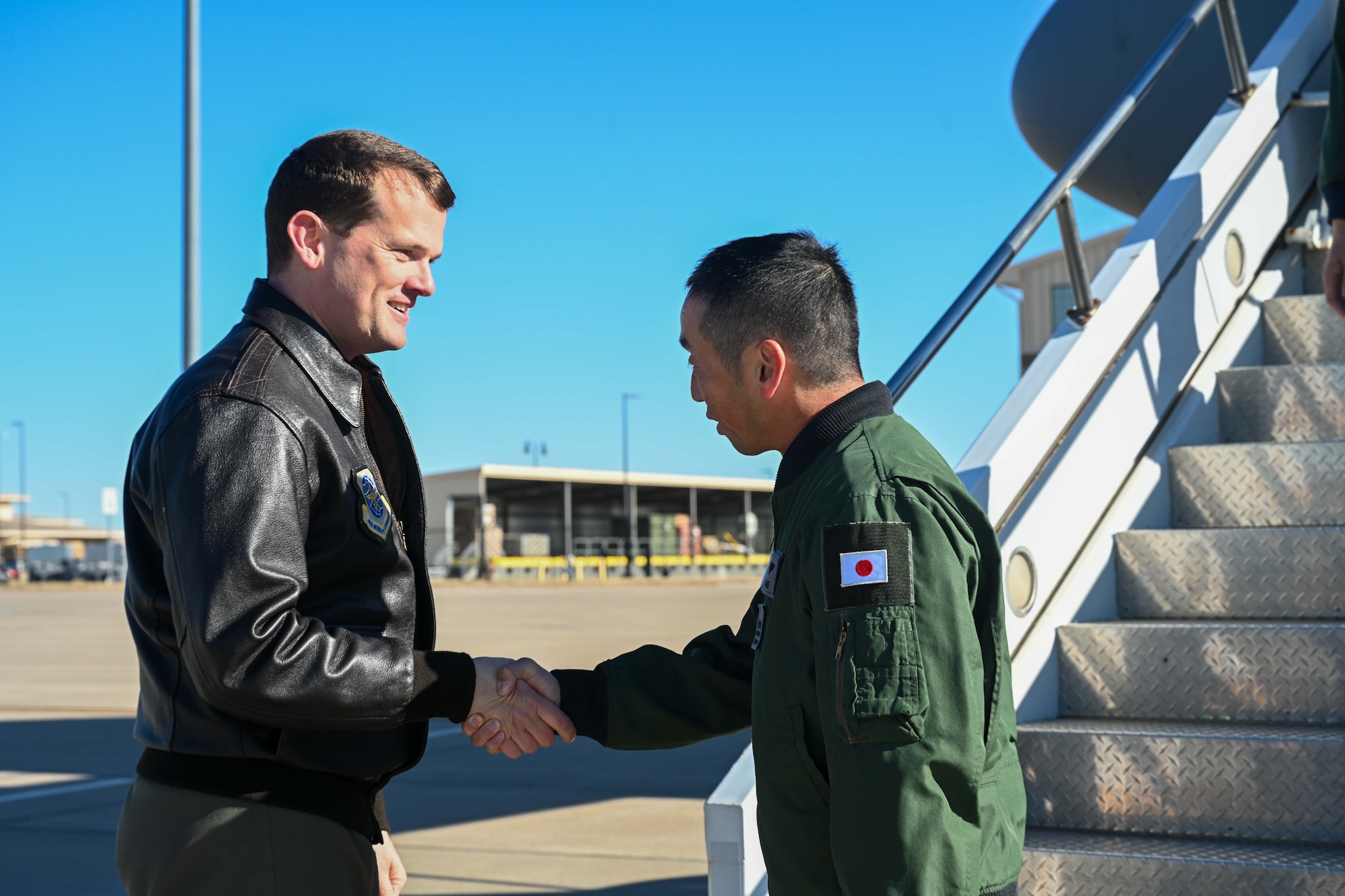 People group around to discuss operational capabilities relating to a KC-46 refueling airplane.