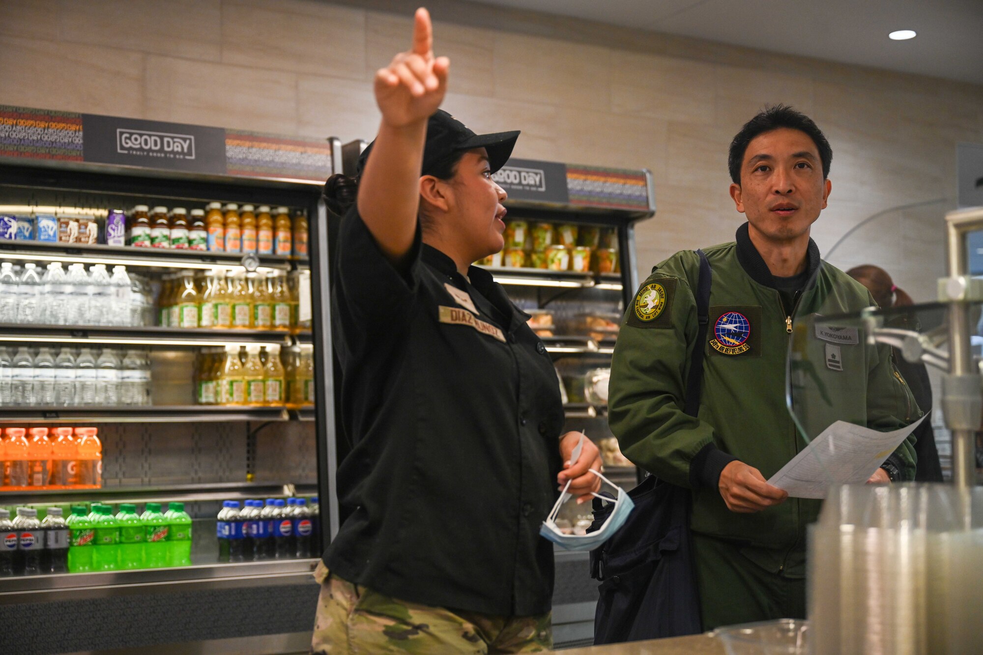 People group around to discuss operational capabilities relating to a KC-46 refueling airplane.