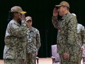 U.S. Navy Capt. Cherie Taylor, incoming commander of Task Force (TF) 53, left, relieves Capt. Christopher K. Brusca, outgoing commander of TF 53, during a change of command ceremony onboard Naval Support Activity Bahrain.