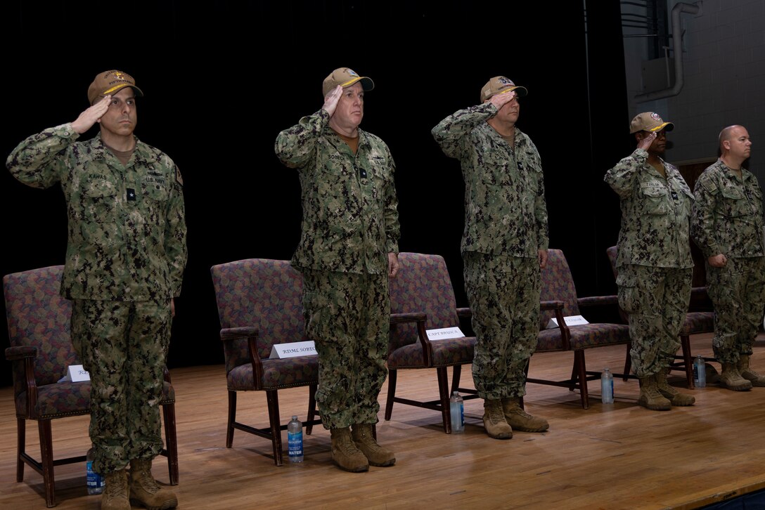 The official party renders salutes during the Task Force 53 change of command ceremony onboard Naval Support Activity Bahrain.
