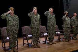 The official party renders salutes during the Task Force 53 change of command ceremony onboard Naval Support Activity Bahrain.