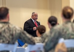 Secretary of the Navy Carlos Del Toro addresses service members, civilians and their families during an all-hands call onboard Naval Support Activity Bahrain.