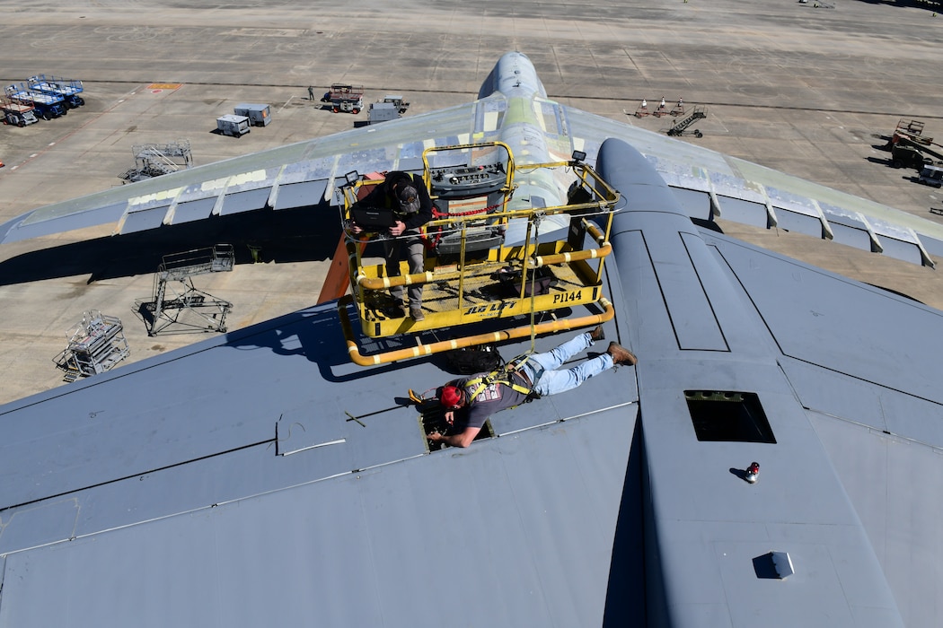 Maintainers work on the tail of a C-5 aircraft