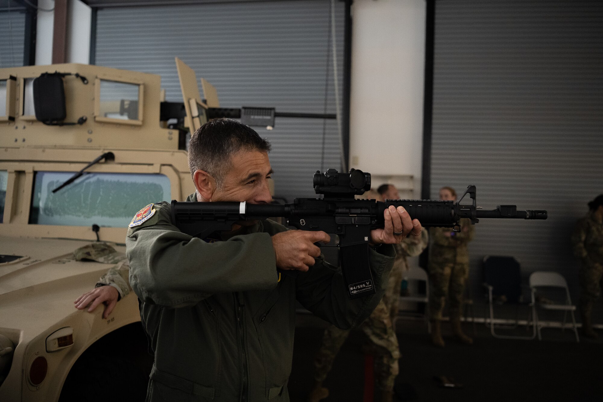 A man looks down the scope of a rifle.