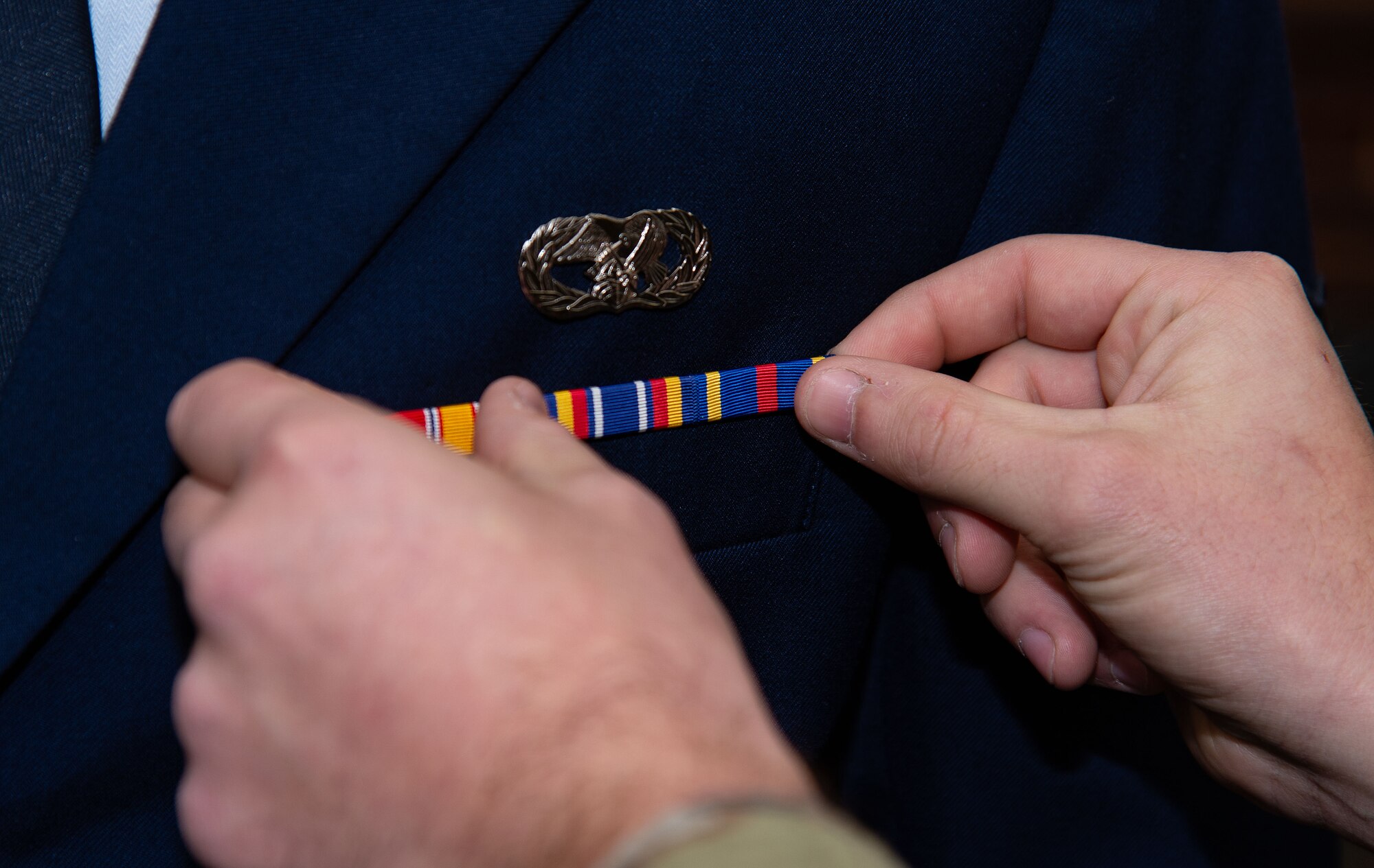 U.S. Air Force Senior Airman Scott Liskey, Dover Base Honor Guard member, adjusts the placement of ribbons on Airman 1st Class Randy Robertson, 436th Logistics Readiness Squadron ground transportation journeyman, during the Below-The-Zone Prep Course on Dover Air Force Base, Delaware, Nov. 14, 2024. Fourteen BTZ-eligible candidates received nine hours of hands-on board practice plus 10 hours of curriculum focused on professional presentation, public speaking, and dress and appearance applications. (U.S. Air Force photo by Roland Balik)