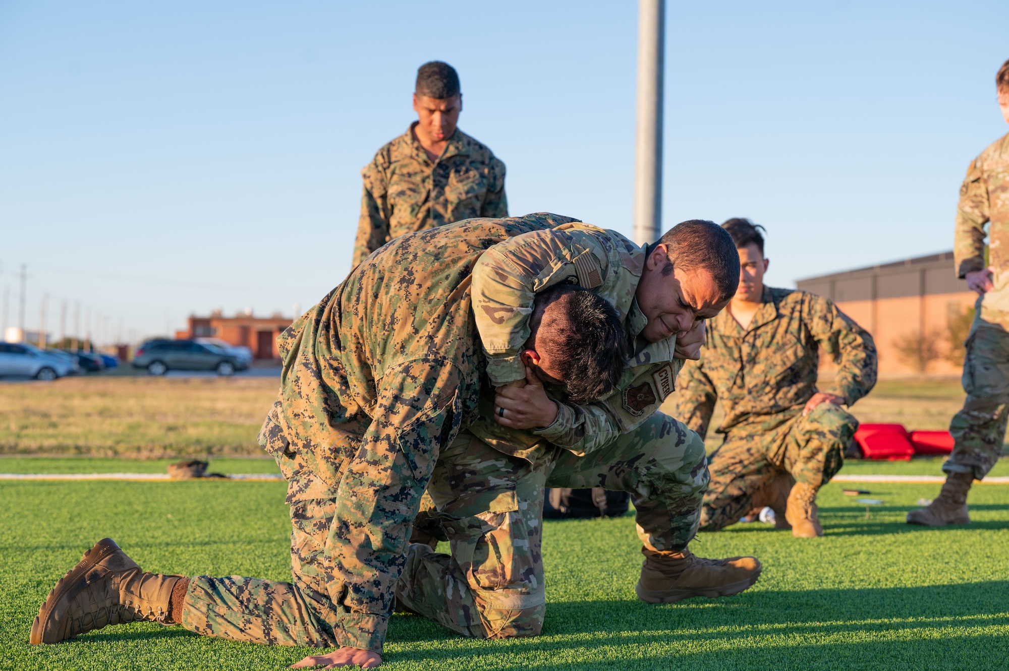 U.S. Air Force Airman 1st Class Carlos Gonzales and a U.S. Marine Corps Marine, Marine Corps Martial Arts Program students, practice fighting techniques during MCMAP at Dyess Air Force Base, Texas, Nov. 21, 2024. Joint training fosters a camaraderie and mutual understanding between branches, leading to better integration and operations during missions. (U.S. Air Force photo by Airman 1st Class Emma Anderson)