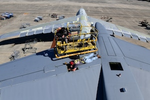 Maintainers work on the tail of a C-5 aircraft