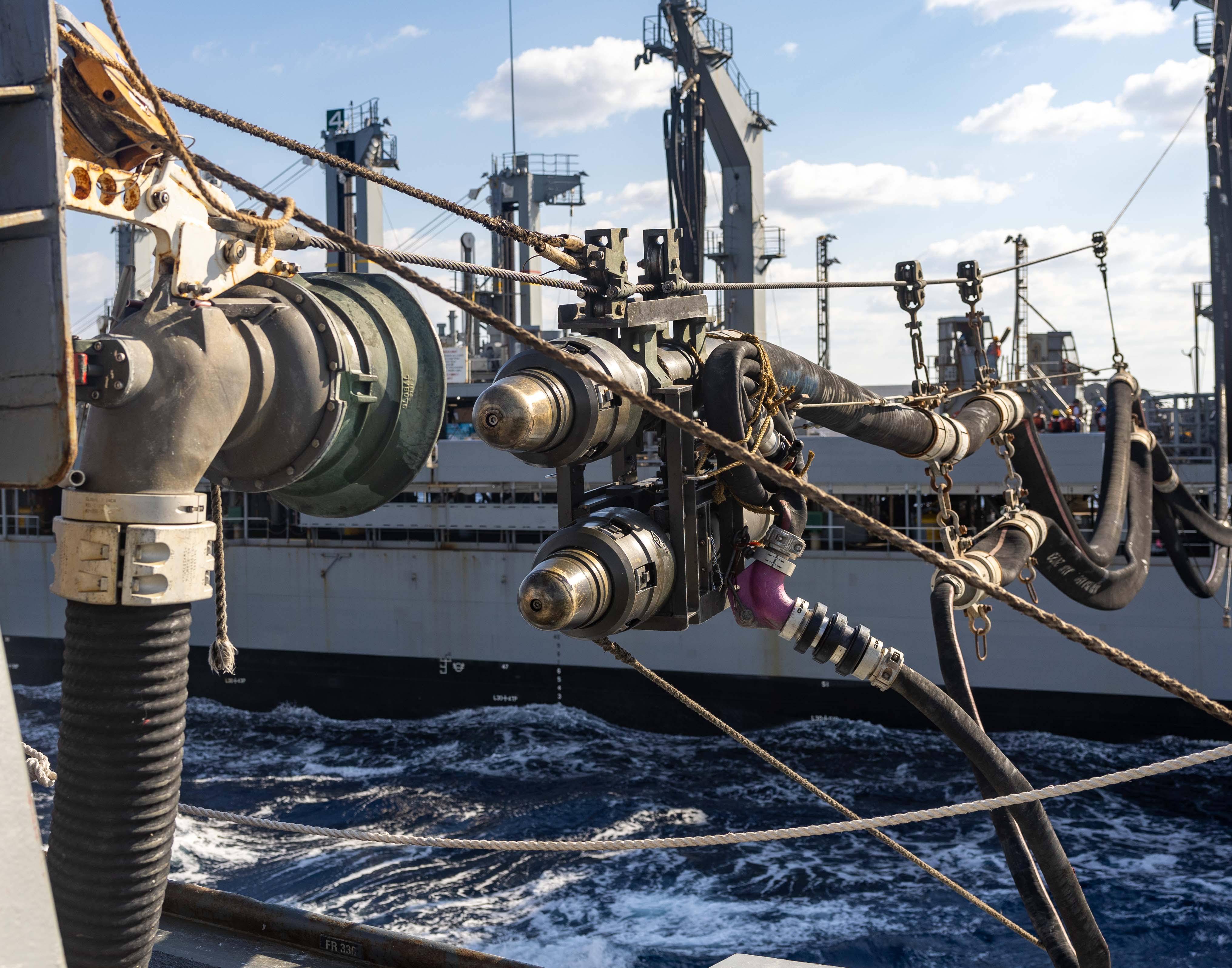 A fueling probe from the Henry J. Kaiser-class fleet replenishment oiler USNS Tippecanoe (T-AO 199) is guided to a bell housing aboard the Arleigh Burke-class guided-missile destroyer USS Preble (DDG 88) during a replenishment at sea in the Philippine Sea, Dec. 10. Commander, Task Force 73 (CTF-73) in coordination with Military Sealift Command Far East (MSC FE) refuels and resupplies deployed naval forces, along with regional allies and partners in the Indo-Pacific. Preble is forward-deployed and assigned to Destroyer Squadron (DESRON) 15, the Navy's largest DESRON and the U.S. 7th Fleet's principal surface force.