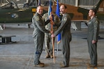 U.S. Air Force Col. John Anderson, 12th Operations Group commander, hands the unit guidon to Lt. Col. Joshua Stallard to assume command of the 560th Flying Training Squadron during a change of command ceremony December 16, 2024, at Joint Base San Antonio-Randolph, Texas. The 560th FTS qualifies fighter and bomber pilots as instructor pilots in the T-38C Talon. The squadron executes eight syllabi to train Air Force instructor pilots, Air Force and U.S. Navy test pilot school candidates, allied nation fighter and instructor pilots, and Air Force pilots identified for transition to fighter aircraft. The squadron currently flies a total of 8,800 hours annually in a fleet of nearly 40 aircraft and produces about 130 graduates per year. (U.S. Air Force photo by Sean Worrell)