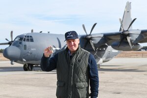 “Downtown” Josh Brown poses for a photo with his commander’s coin in front of an HC-130J Combat King II search and rescue aircraft at the New York Air National Guard’s 106th Rescue Wing, Francis S. Gabreski Air National Guard Base, Westhampton Beach, N.Y., Dec. 8, 2024.