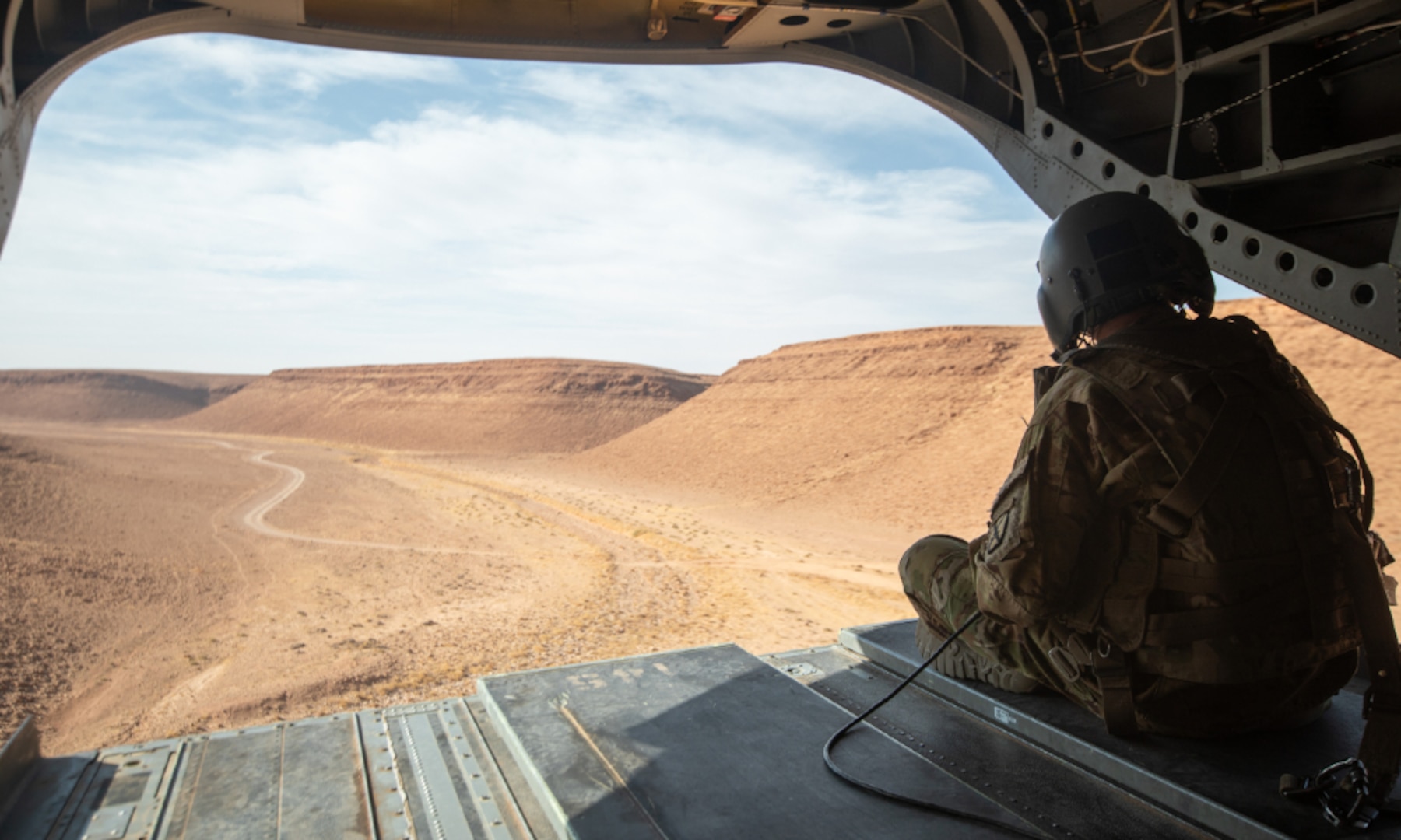 A U.S. Army soldier looks out from a CH-47 Chinook helicopter near Al-Tanf Garrison, Syria.