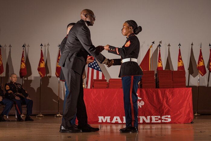 Retired U.S. Marine Corps Master Gunnery Sgt. William Barr, the guest of honor, gives the graduation certificates during the Basic Recruiter’s Course 1-25 graduation at Marine Corps Recruit Depot San Diego, California, Dec. 13, 2024. The mission of the BRC is to provide staff noncommissioned officers and noncommissioned officers the basic skills and knowledge in order to successfully inform young men and women about the opportunities and career paths the Marine Corps has to offer. (U.S. Marine Corps photo by Lance Cpl. Janell B. Alvarez)