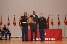 U.S Marine Corps Sergeant Major of Recruiters School, Sgt. Maj. Antonio J. Colon, left, Marine Corps Recruiting Command, Retired Master Gunnery Sgt. William Barr, center, the guest of honor, and the Commanding Officer of Recruiters School, Maj. Stephanie Damren, Marine Corps Recruiting Command, pose for a photo at the Basic Recruiter’s Course 1-25 graduation at Marine Corps Recruit Depot San Diego, California, Dec. 13, 2024. The mission of the BRC is to provide staff noncommissioned officers and noncommissioned officers the basic skills and knowledge in order to successfully inform young men and women about the opportunities and career paths the Marine Corps has to offer. (U.S. Marine Corps photo by Lance Cpl. Janell B. Alvarez)