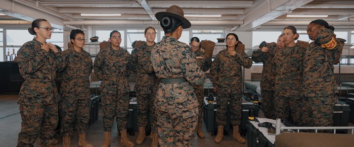 U.S. Marine Corps Drill Instructor, Sgt. Maria Delacruz, with Fox Company, 2nd Recruit Training Battalion, briefs Marines before a company commander’s inspection at Marine Corps Recruit Depot San Diego, California, Dec. 14, 2024. The company commander's inspection surveys new Marines for knowledge, bearing, and attention to detail before the battalion commander’s inspection, one of their last tests before graduating. (U.S. Marine Corps photo by Lance Cpl. Janell B. Alvarez)