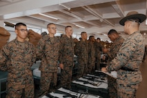 U.S. Marine Corps Company Commander, Capt. Brandon Carter, right, and Senior Drill Instructor, Staff Sgt. Arturo DelToro, both with Fox Company, 2nd Recruit Training Battalion, conduct a company commander’s inspection at Marine Corps Recruit Depot San Diego, California, Dec. 14, 2024. The company commander’s inspection surveys new Marines for knowledge, bearing, and attention to detail before the battalion commander’s inspection, one of their last tests before graduating. (U.S. Marine Corps photo by Lance Cpl. Janell B. Alvarez)