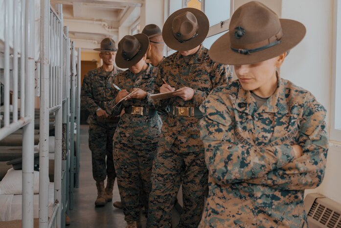 U.S. Marine Corps Drill Instructors, with Fox Company, 2nd Recruit Training Battalion, inspect a squad bay during a company commander’s inspection at Marine Corps Recruit Depot San Diego, California, Dec. 14, 2024. The company commander’s inspection surveys new Marines for knowledge, bearing, and attention to detail before the battalion commander’s inspection, one of their last tests before graduating. (U.S. Marine Corps photo by Lance Cpl. Janell B. Alvarez)t