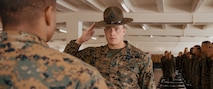U.S. Marine Corps Senior Drill Instructor, Staff Sgt. Riley Cotton, with Fox Company, 2nd Recruit Training Battalion, reports to the Company Commander, Capt. Brandon Carter for a company commander’s inspection at Marine Corps Recruit Depot San Diego, California, Dec. 14, 2024. The company commander’s inspection surveys new Marines for knowledge, bearing, and attention to detail before the battalion commander’s inspection, one of their last tests before graduating. (U.S. Marine Corps photo by Lance Cpl. Janell B. Alvarez)