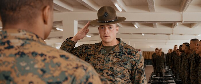 U.S. Marine Corps Senior Drill Instructor, Staff Sgt. Riley Cotton, with Fox Company, 2nd Recruit Training Battalion, reports to the Company Commander, Capt. Brandon Carter for a company commander’s inspection at Marine Corps Recruit Depot San Diego, California, Dec. 14, 2024. The company commander’s inspection surveys new Marines for knowledge, bearing, and attention to detail before the battalion commander’s inspection, one of their last tests before graduating. (U.S. Marine Corps photo by Lance Cpl. Janell B. Alvarez)