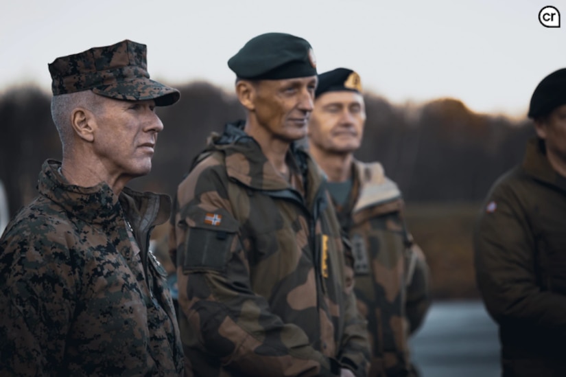 Commanding Marine Corps officers stand outside in a cold day.