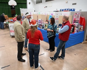 group of people talking near toys