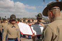 U.S. Marine Corps Drill Instructors, Staff Sgt. Burruel Delacruz, left, and Staff Sgt. Barry Clayton, back right, both with Charlie Company, 1st Recruit Training Battalion, are presented a Navy and Marine Corps Achievement Medal at Marine Corps Recruit Depot San Diego, California, Dec. 13, 2024. A NAM is given to members of the U.S. Navy and Marine Corps for meritorious service or achievement. Delacruz and Clayton received a NAM for exemplifying unrivaled courage and extraordinary presence of mind when confronting a life-threatening emergency. The words “drill instructor, drill instructor, drill instructor” were called and Delacruz and Clayton sprang into action to save a fourteen-month-old infant who was unconscious and not breathing. Providing CPR and proper throat sweeping techniques they successfully dislodged the obstruction and the infant regained consciousness. Likely saving baby Aisla’s life.  The family of the infant was onsite during the ceremony and presented the awards. The Marine Corps has served the Nation honorably for 250 years. Marines embody the uncompromising standards and characteristics of honor, courage and commitment.