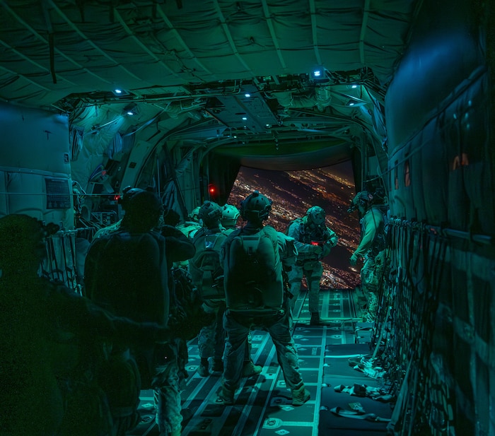 U.S. Marines prepare to conduct a night-time high-altitude, low-opening jump from an HC-130J Combat King II aircraft.