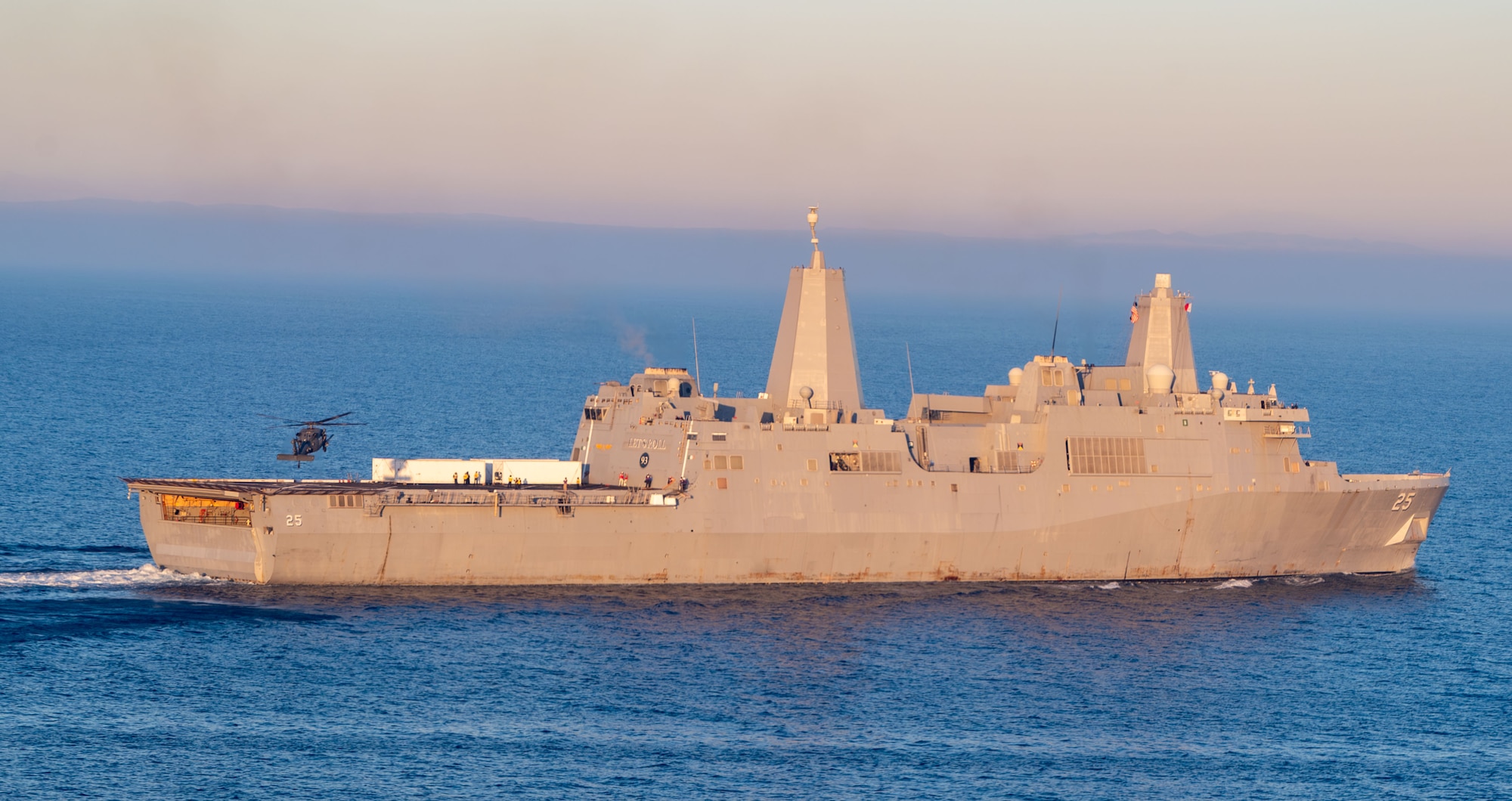 A U.S. Air Force HH-60W Jolly Green II helicopter lands on amphibious transport dock ship USS Somerset (LPD-25)