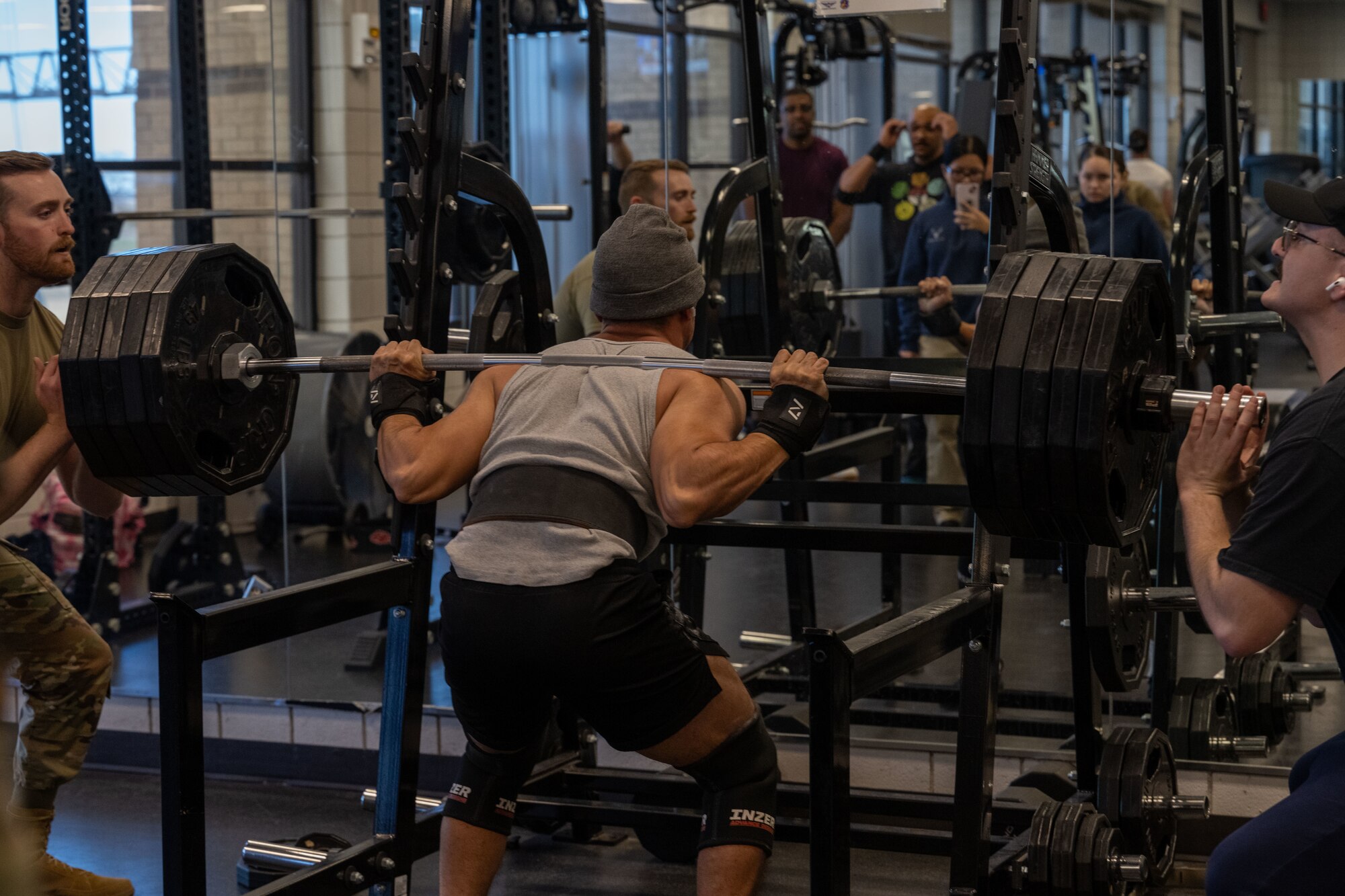 Airman 1st Class Jesus Velasco-Contreras, 22nd Force Support Squadron services apprentice, performs a squat during a base weightlifting competition Dec. 11, 2024, at McConnell Air Force Base, Kansas. Velasco-Contreras successfully performed a 495-pound squat during the competition. (U.S. Air Force photo by Airman 1st Class Paula Arce)