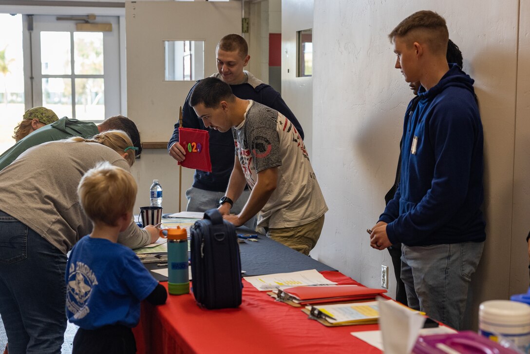 Participants sign in for a Devil Pups event at Marine Corps Recruit Depot San Diego, California, Dec. 14, 2024. The Devil Pups event is held in order to allow participants, aged five to twelve-years-old, to learn about Marine Corps culture, history, and traditions. This program is also a part of the Lifestyle, Insight, Network, Knowledge, and Skills Program, an interactive acculturation program to the Marine Corps lifestyle. (U.S. Marine Corps photo by Lance Cpl. Jacob B. Hutchinson).