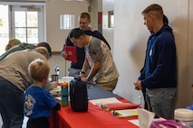 Participants sign in for a Devil Pups event at Marine Corps Recruit Depot San Diego, California, Dec. 14, 2024. The Devil Pups event is held in order to allow participants, aged five to twelve-years-old, to learn about Marine Corps culture, history, and traditions. This program is also a part of the Lifestyle, Insight, Network, Knowledge, and Skills Program, an interactive acculturation program to the Marine Corps lifestyle. (U.S. Marine Corps photo by Lance Cpl. Jacob B. Hutchinson).