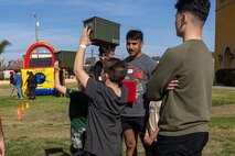 Participants execute ammo-can lifts during a Devil Pups event at Marine Corps Recruit Depot San Diego, California, Dec. 14, 2024. The Devil Pups event is held in order to allow participants, aged five to twelve-years-old, to learn about Marine Corps culture, history, and traditions. This program is also a part of the Lifestyle, Insight, Network, Knowledge, and Skills Program, an interactive acculturation program to the Marine Corps lifestyle. (U.S. Marine Corps photo by Lance Cpl. Jacob B. Hutchinson)