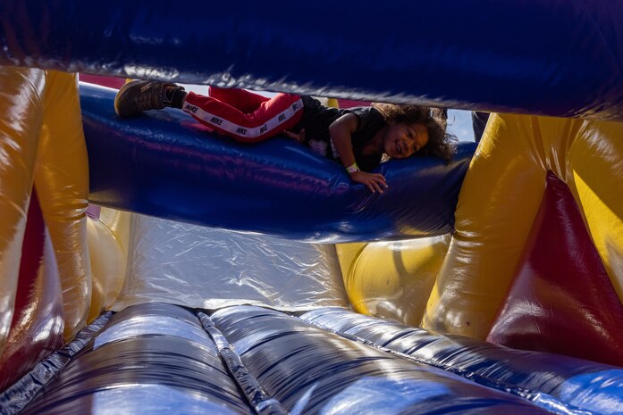 A participant navigates an inflated obstacle course during a Devil Pups event at Marine Corps Recruit Depot San Diego, California, Dec. 14, 2024. The Devil Pups event is held in order to allow participants, aged five to twelve-years-old, to learn about Marine Corps culture, history, and traditions. This program is also a part of the Lifestyle, Insight, Network, Knowledge, and Skills Program, an interactive acculturation program to the Marine Corps lifestyle. (U.S. Marine Corps photo by Lance Cpl. Jacob B. Hutchinson)