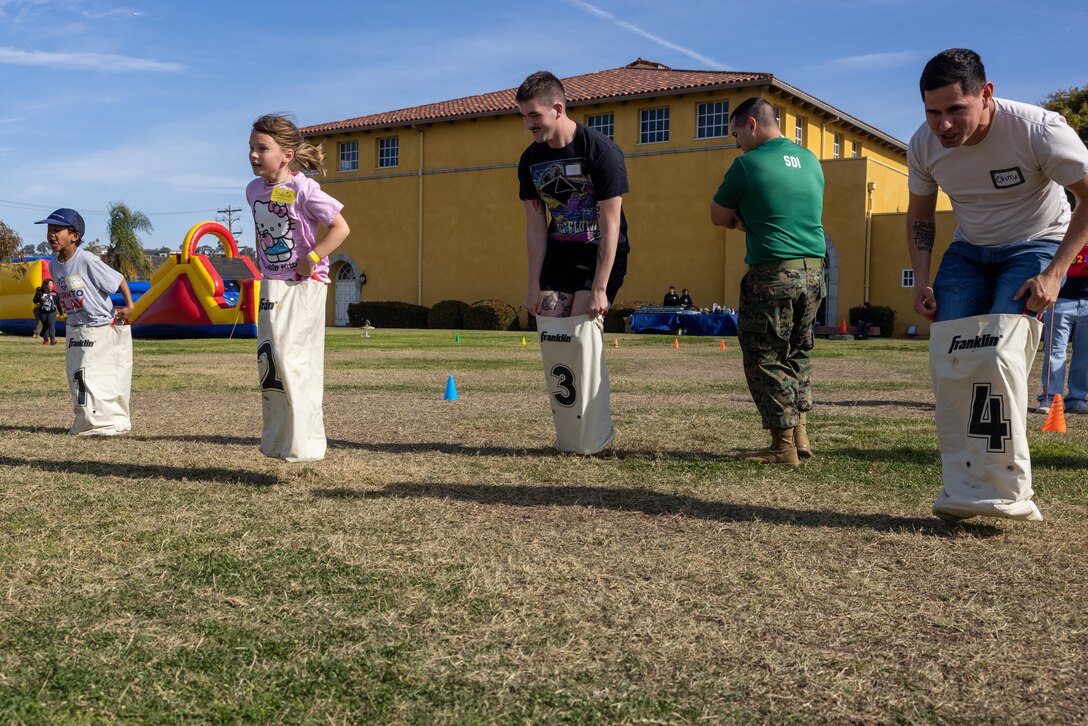 Participants and volunteers, participate in a Devil Pups event at Marine Corps Recruit Depot San Diego, California, Dec. 14, 2024. The Devil Pups event is held in order to allow participants, aged five to twelve-years-old, to learn about Marine Corps culture, history, and traditions. This program is also a part of the Lifestyle, Insight, Network, Knowledge, and Skills Program, an interactive acculturation program to the Marine Corps lifestyle. (U.S. Marine Corps photo by Lance Cpl. Jacob B. Hutchinson)